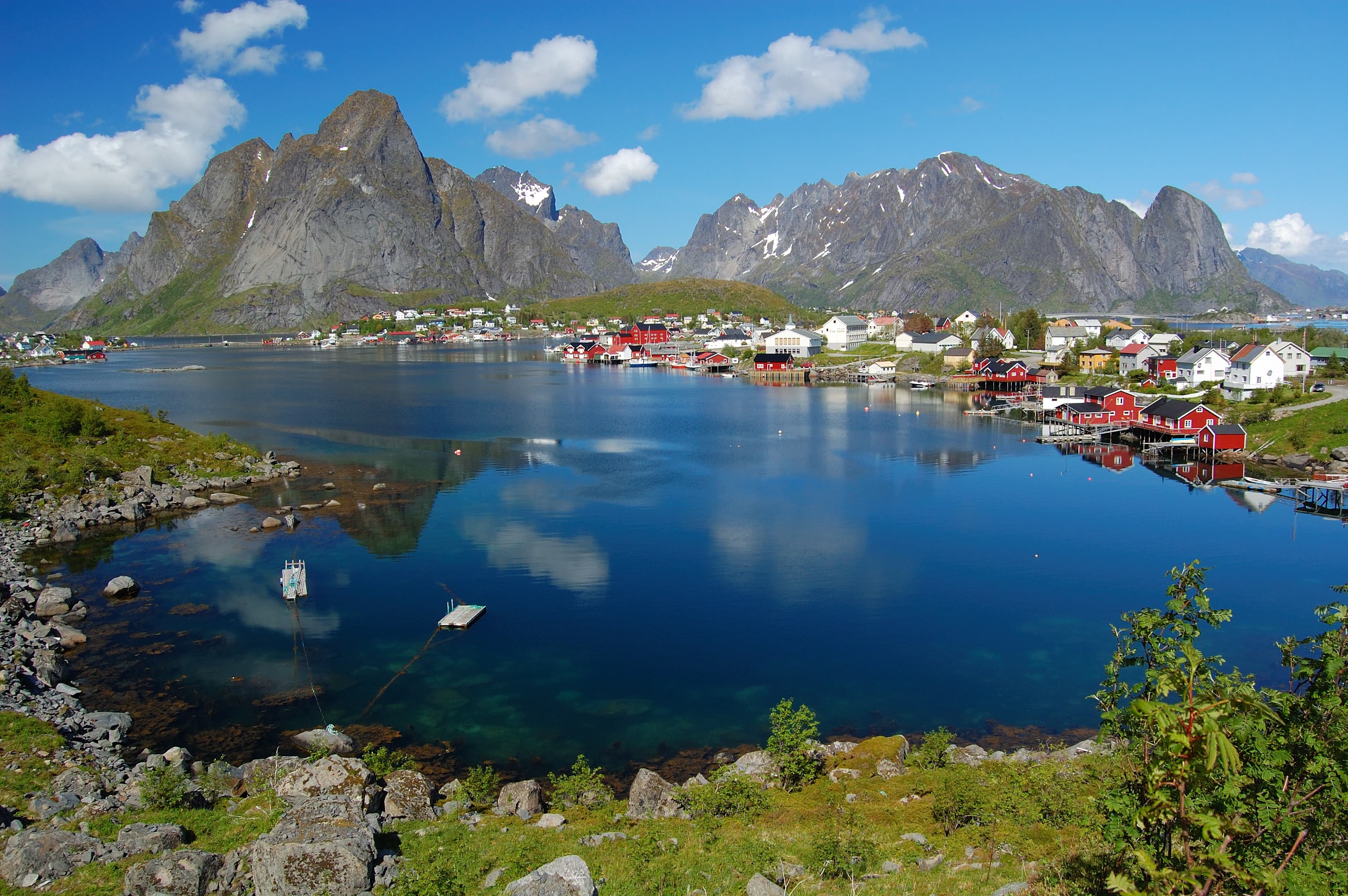 Reine i Lofoten med rorbuer og fjell speilet i vannet
